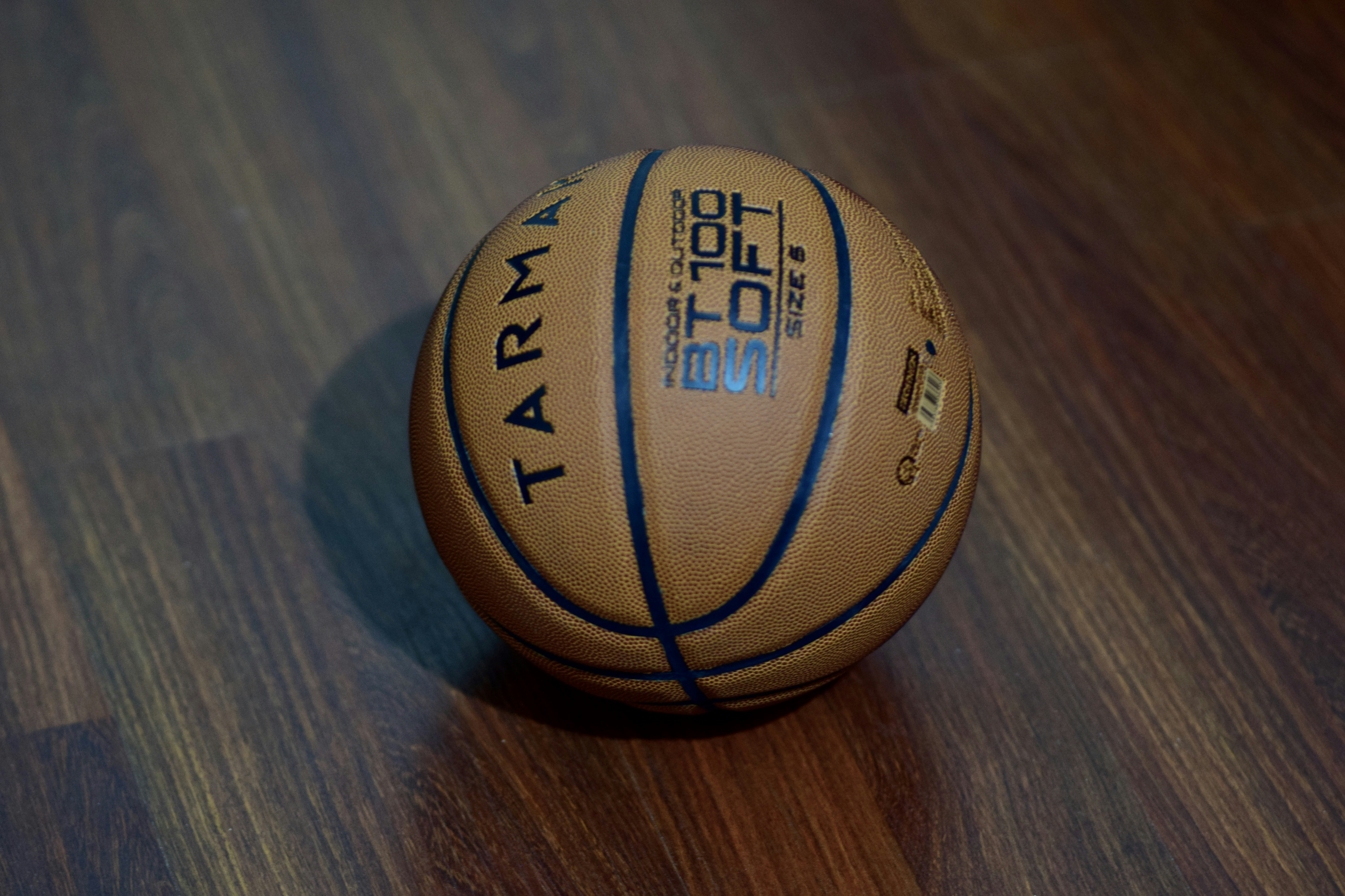 brown and black basketball on brown wooden table