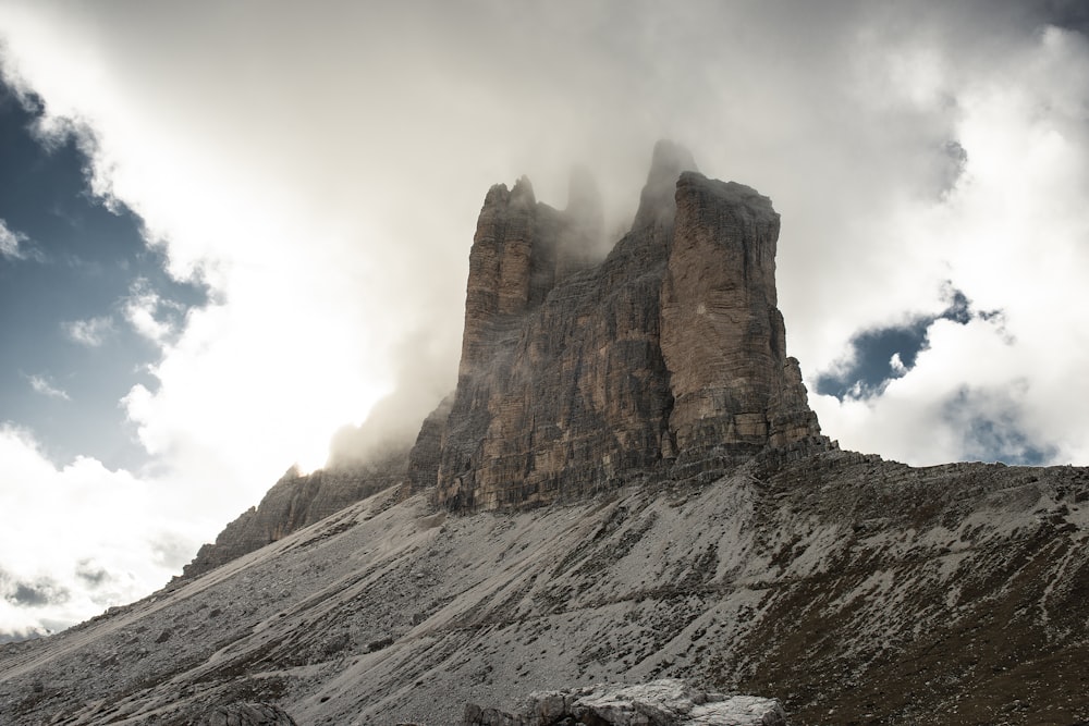 brown rocky mountain under white clouds during daytime