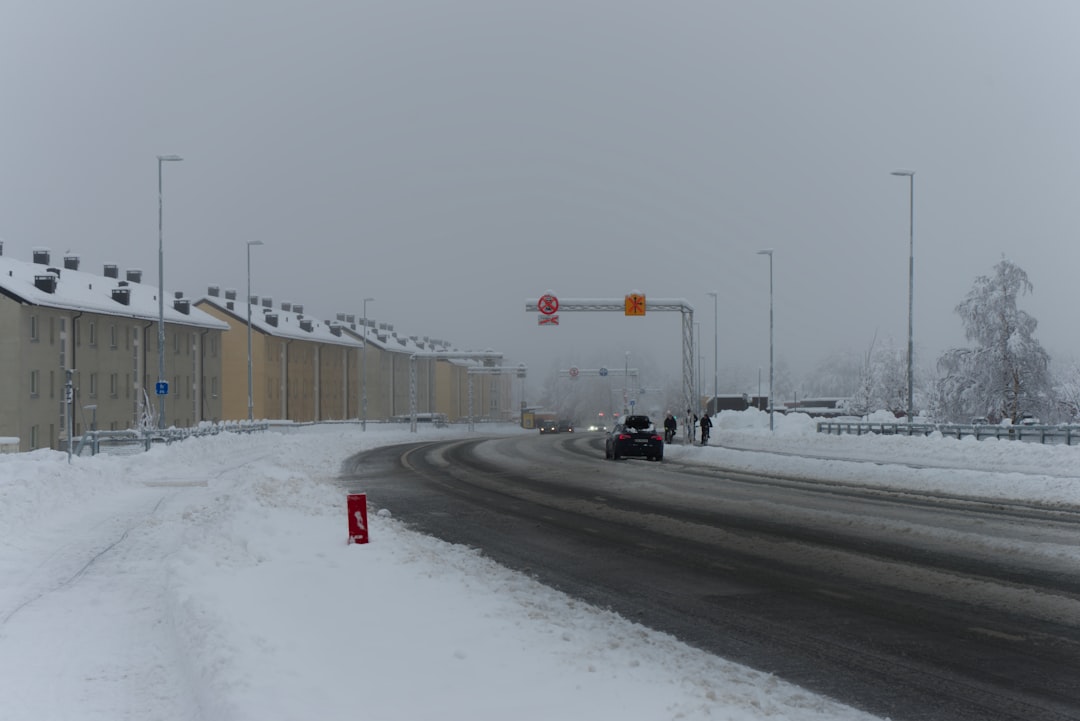 cars on road covered with snow during daytime