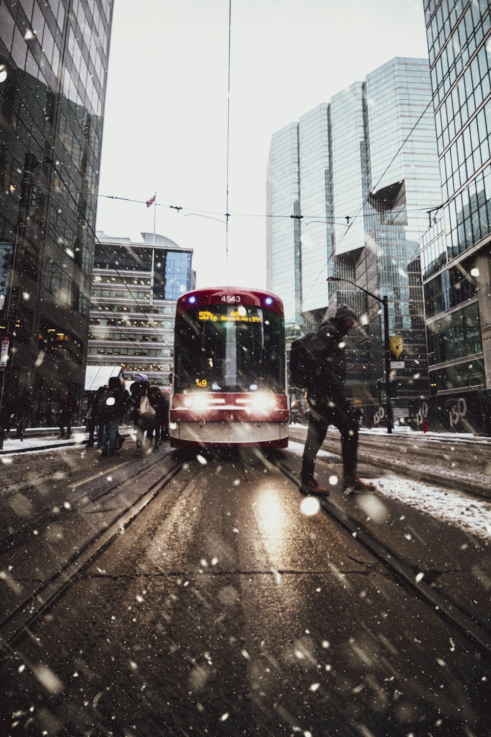 red and purple train on city street during daytime