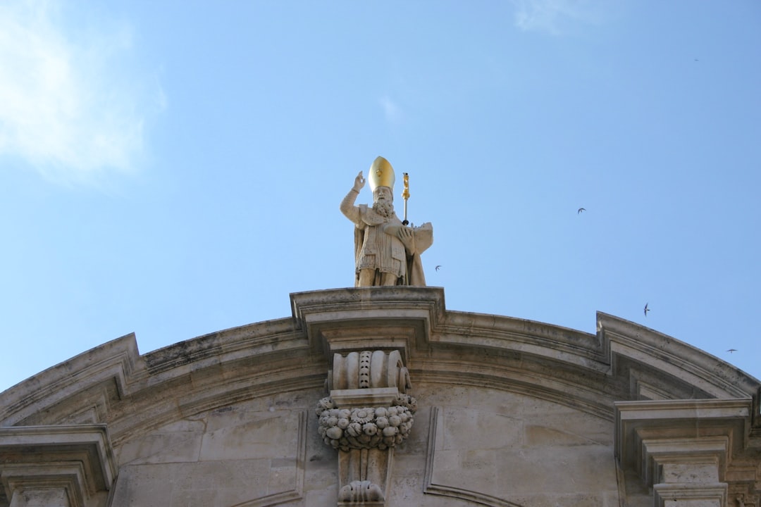 gold statue under blue sky during daytime