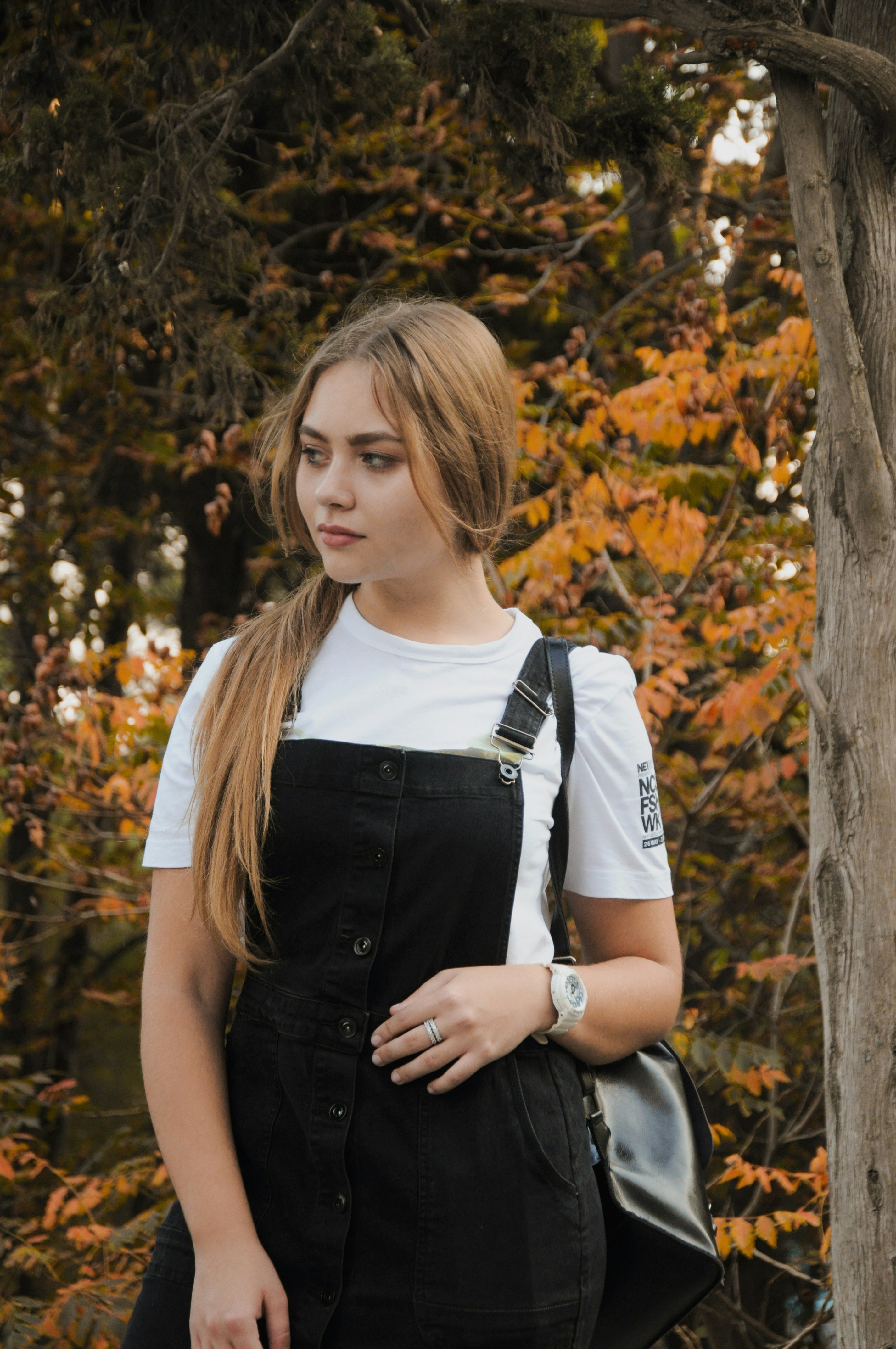 Young woman with long blonde hair wearing a black dress