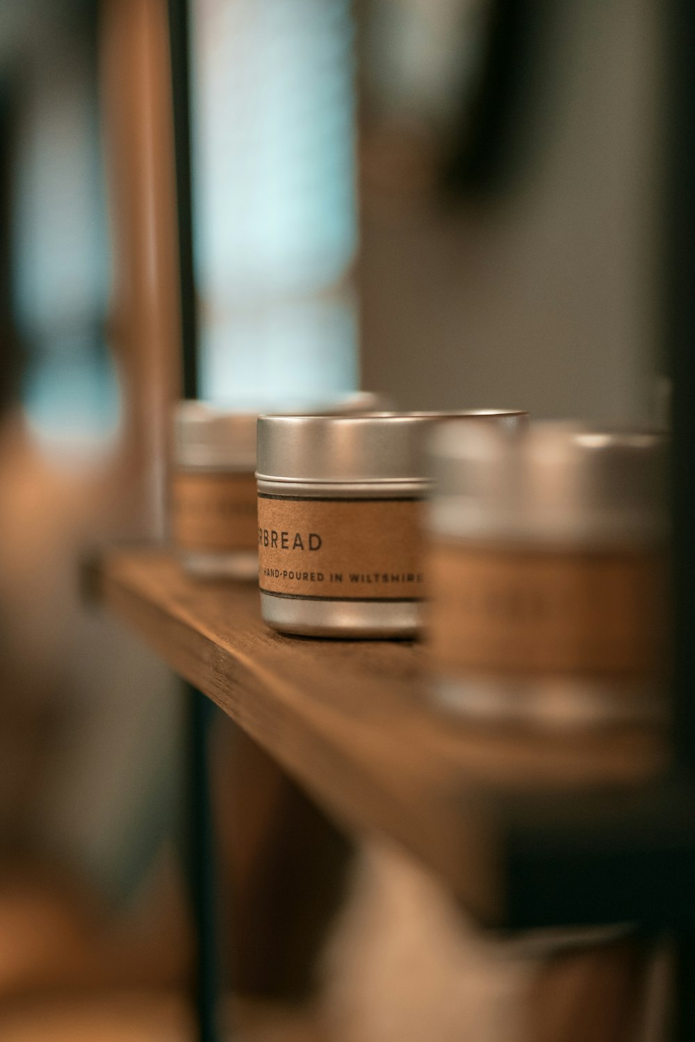 brown and silver round containers on brown wooden table