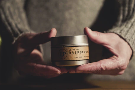Close-up of hands packaging small batch products with care.