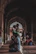 Happy elderly couple praying together inside a mosque with soft lighting.