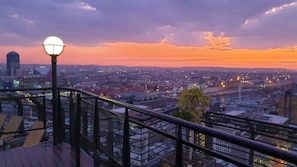 A rooftop view featuring dynamic animations of sunset yellow and orange lights flickering over the cityscape.