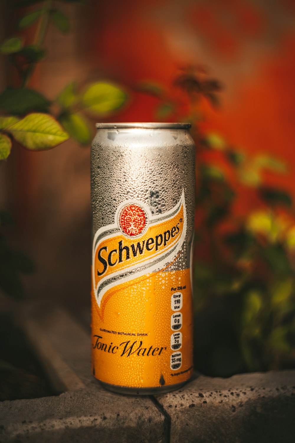 orange and black can on brown wooden table