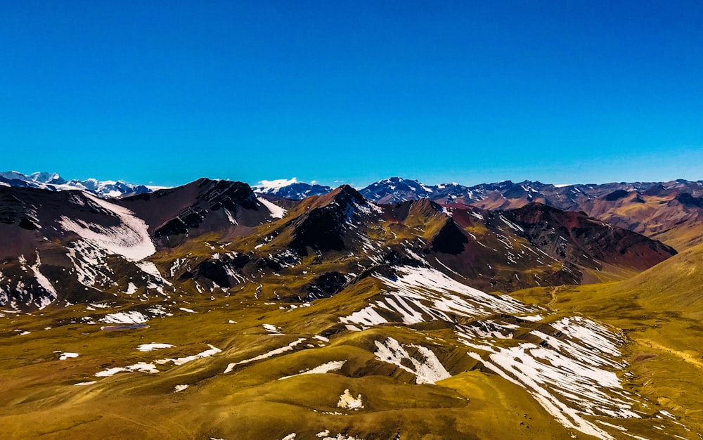 white and black mountains under blue sky during daytime