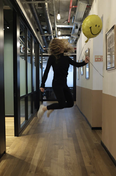 woman in black long sleeve shirt and black pants holding yellow ball