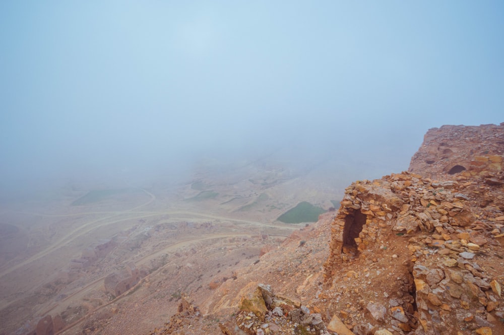 brown rocky mountain under white sky during daytime