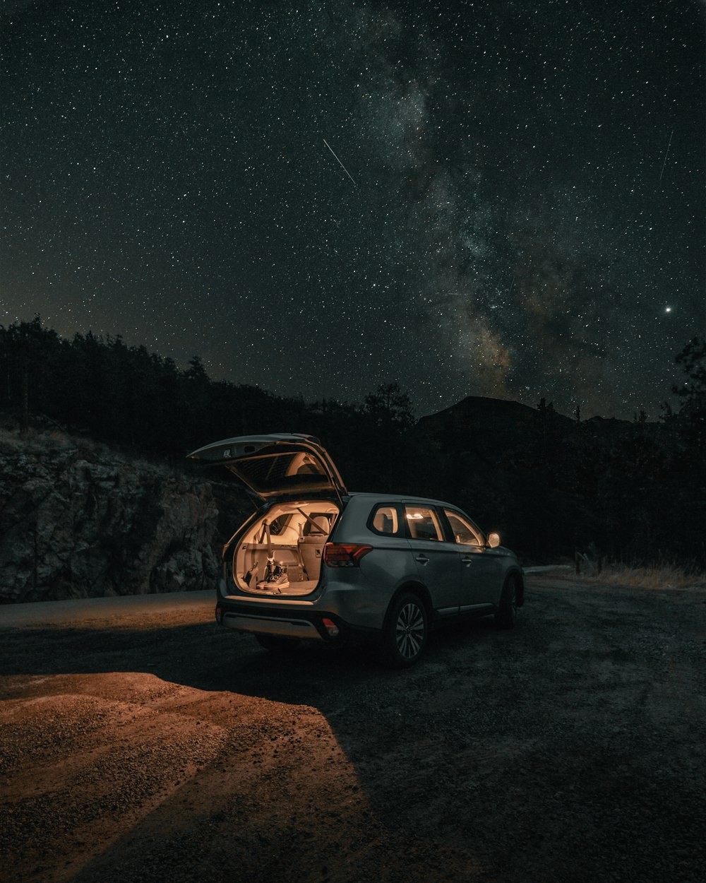 black suv on dirt road during night time