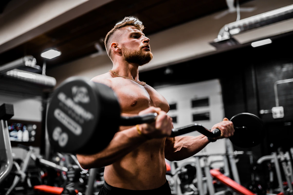 Athlete performing a strength training workout with free weights in a professional gym