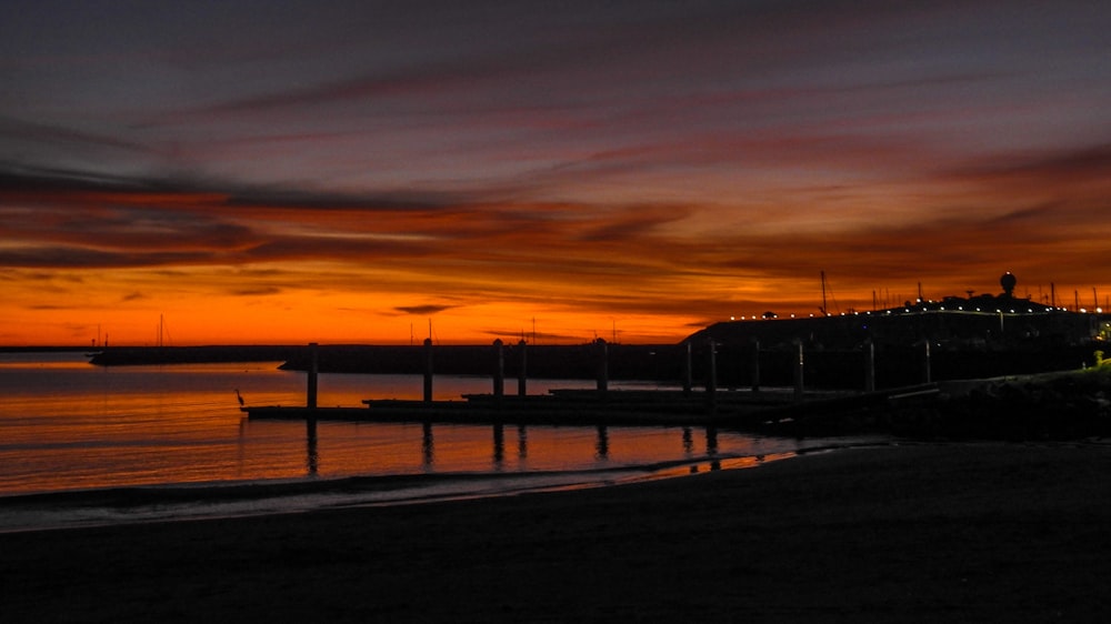 silhouette of dock during sunset