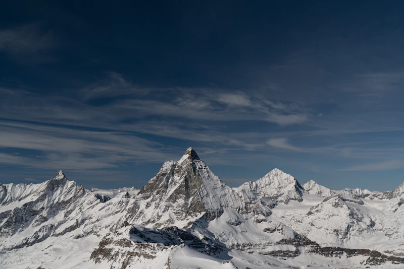The snow-covered Klein Matterhorn above Zermatt under a blue sky