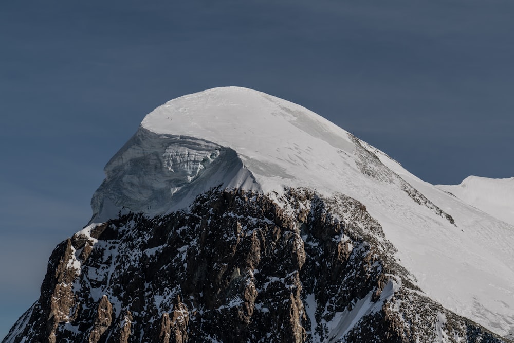 snow covered mountain under blue sky during daytime