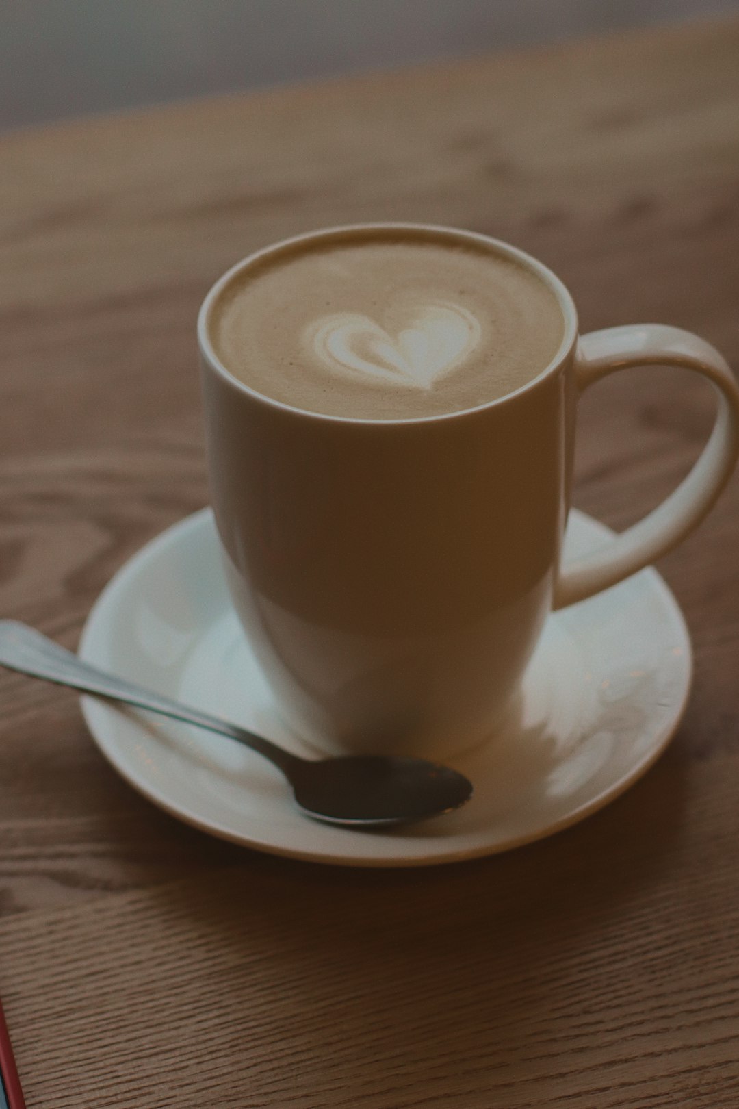 brown ceramic mug on saucer