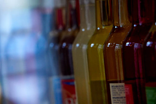 Rows of glass containers filled with colorful fragrance oils.