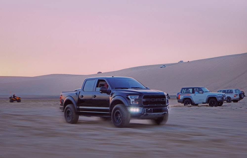 blue chevrolet crew cab pickup truck on desert during daytime