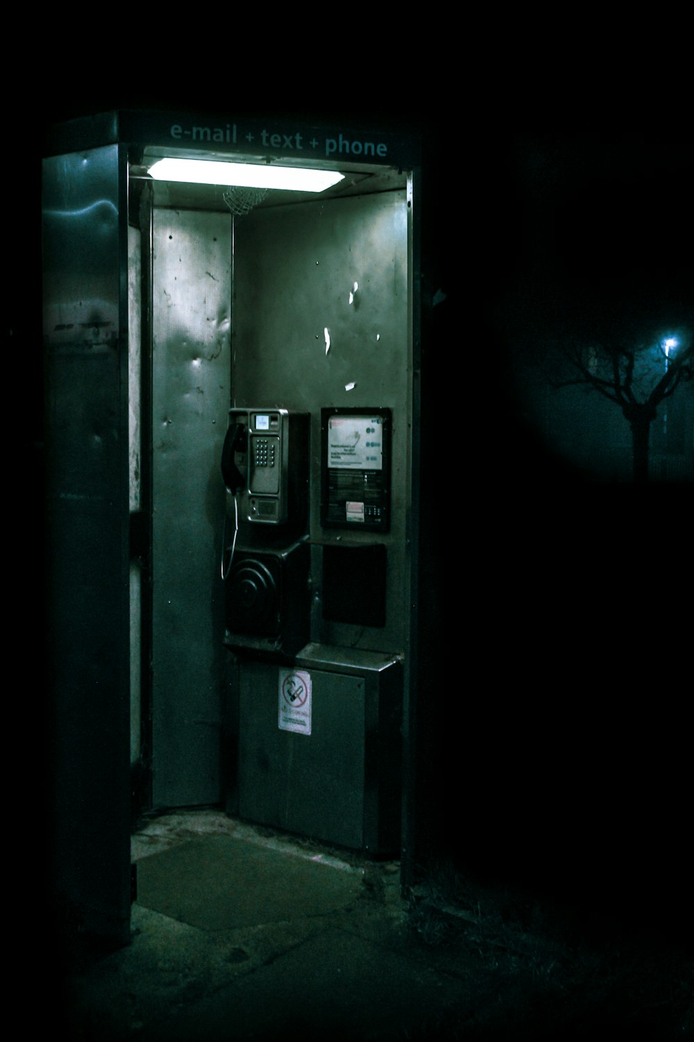 green and black telephone booth