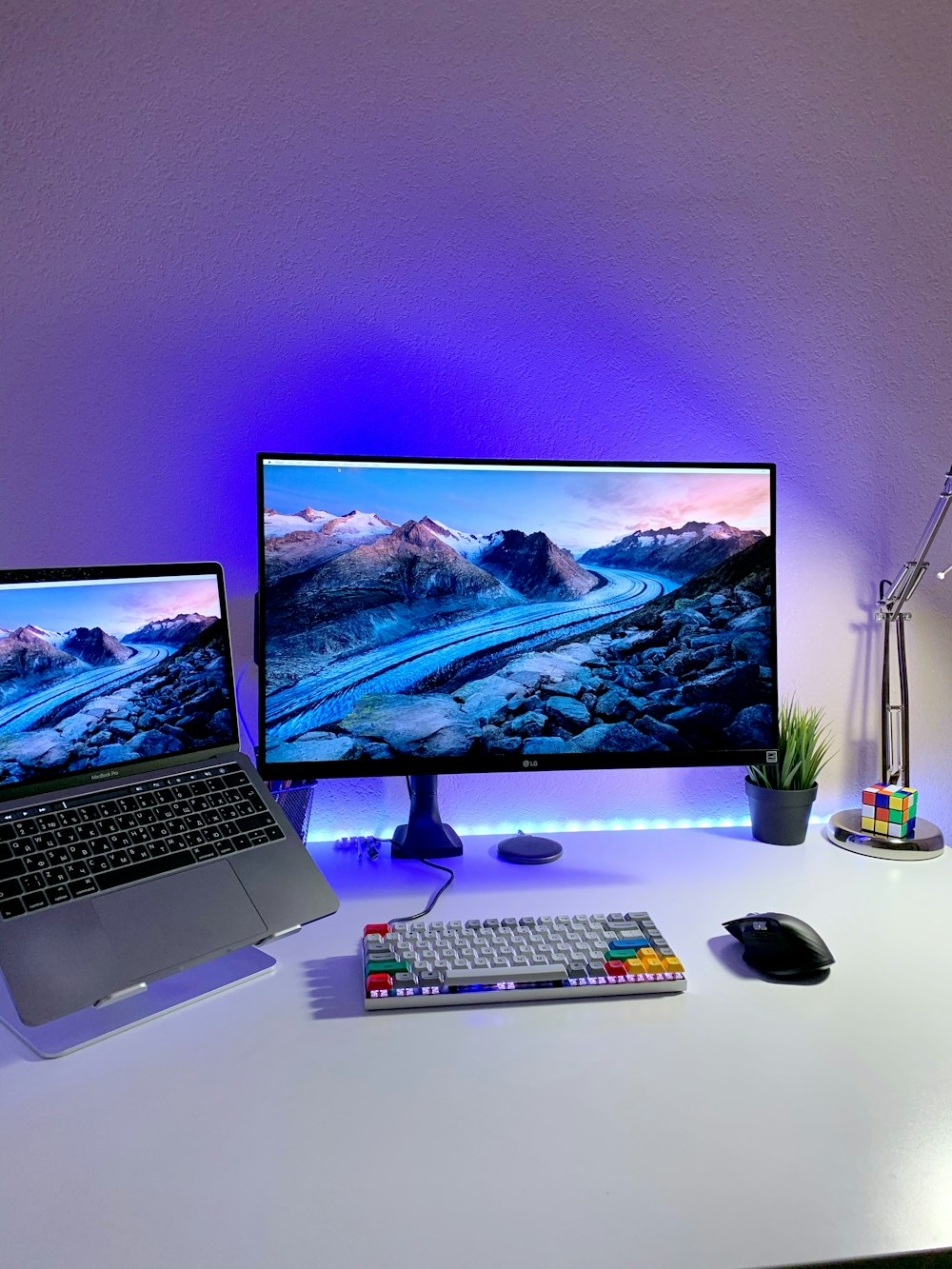 macbook pro beside black computer mouse and black computer keyboard