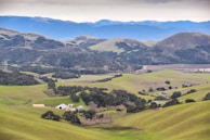 A scenic view of the farm with rolling hills in the background.