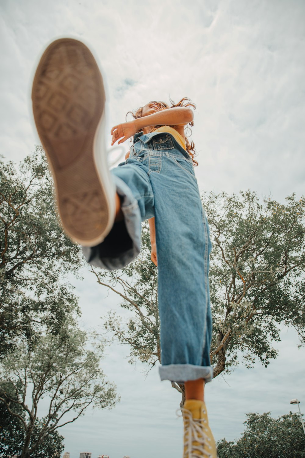 person in blue denim jeans and brown shoes