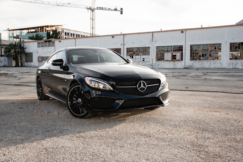 black mercedes benz coupe parked on gray concrete road during daytime