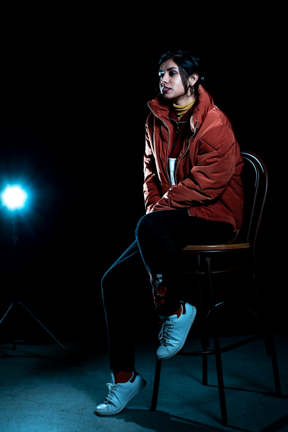 man in red jacket sitting on chair