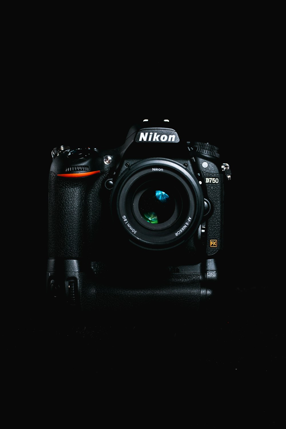 black nikon dslr camera on black surface