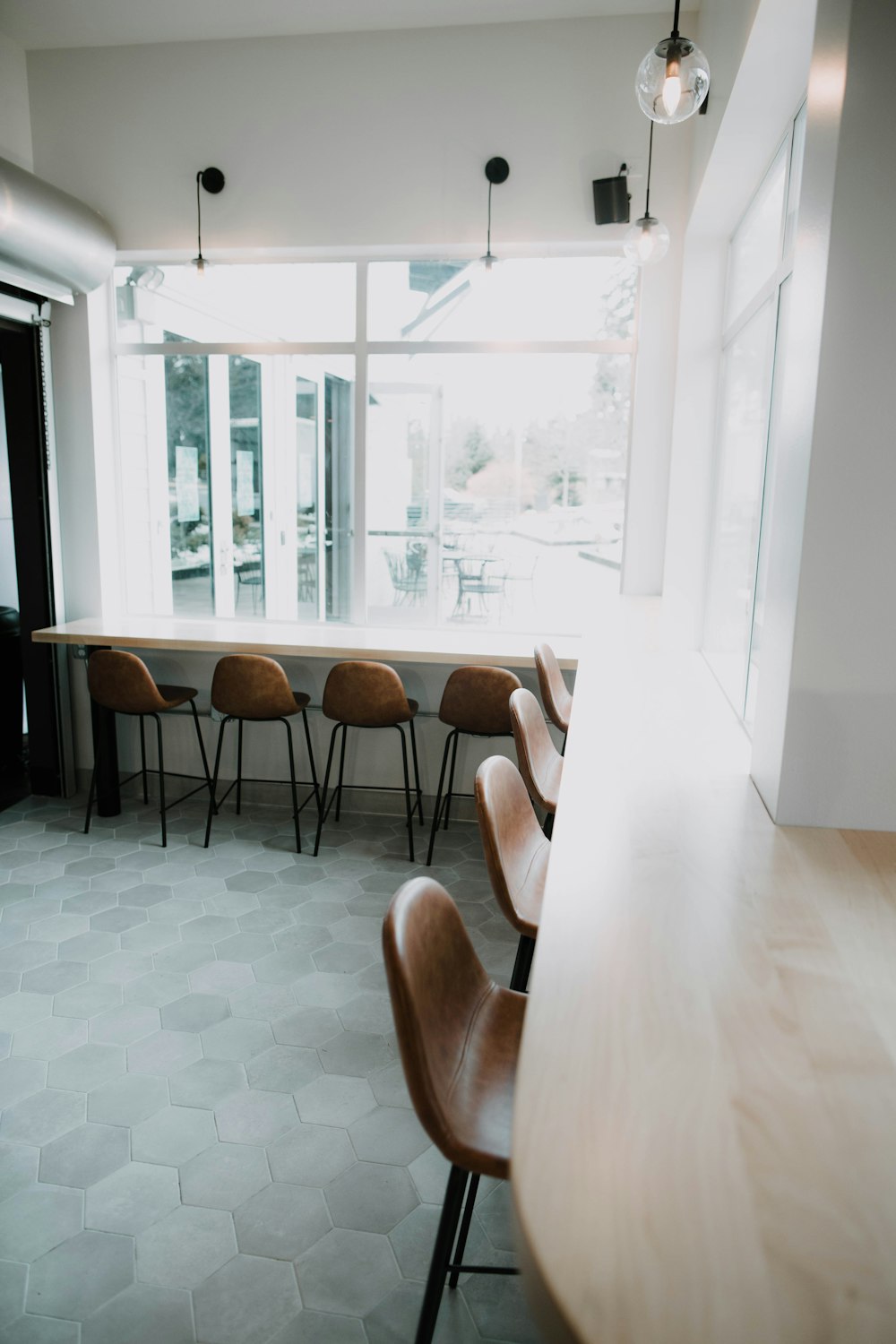 brown wooden framed brown padded chairs