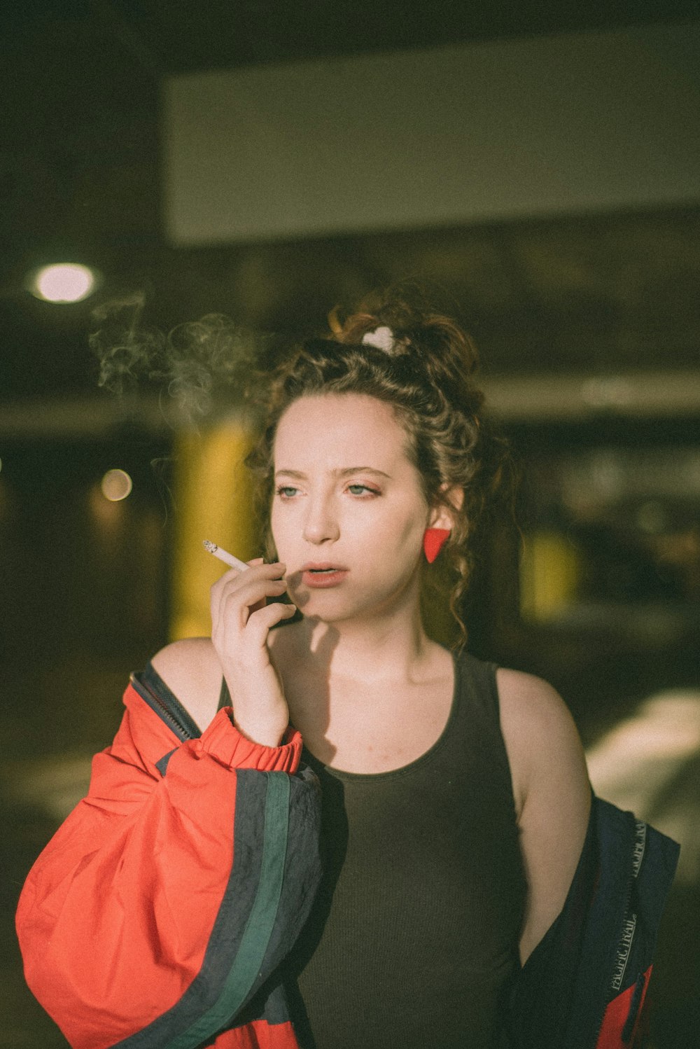 woman in black tank top smoking cigarette