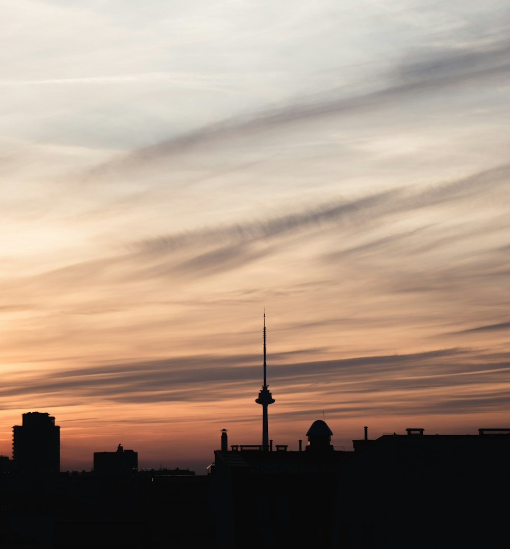 silhouette of city buildings during sunset