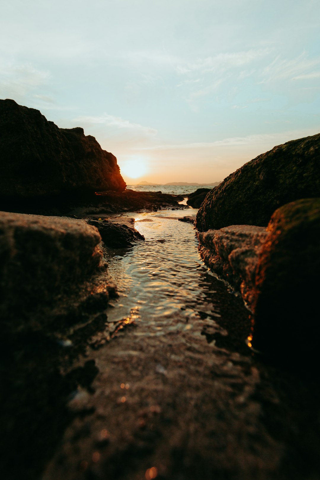 brown rock formation on body of water during daytime