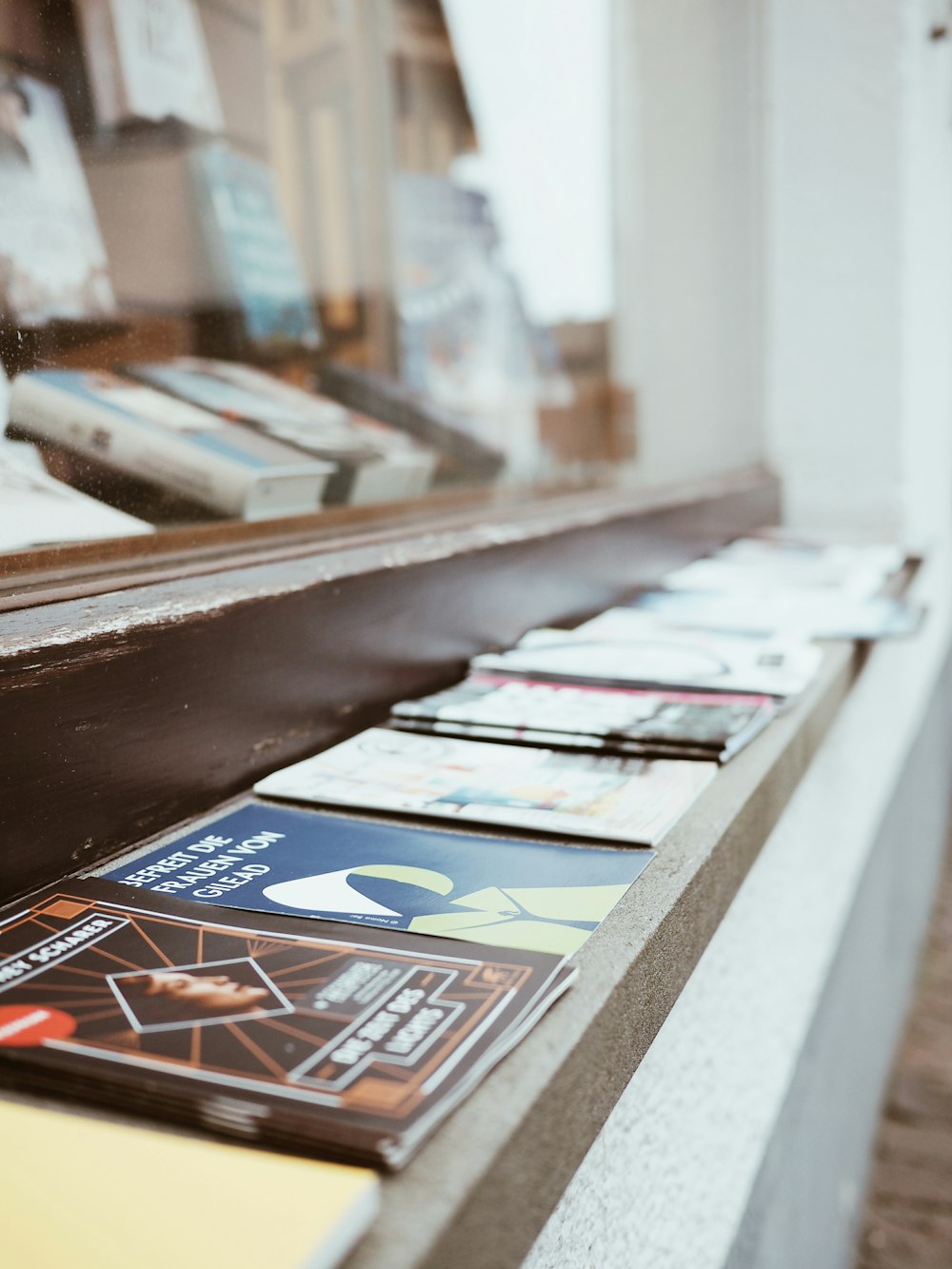 magazines on brown wooden shelf