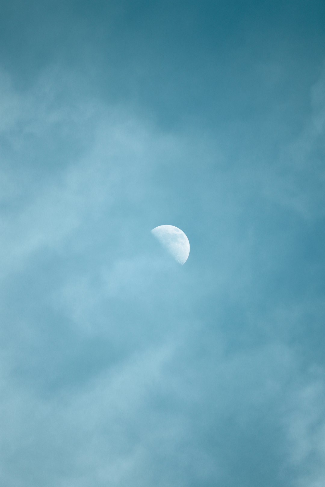 white moon in blue sky