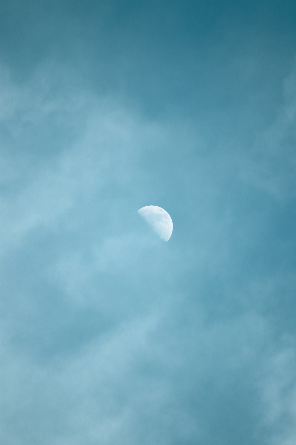 white moon in blue sky