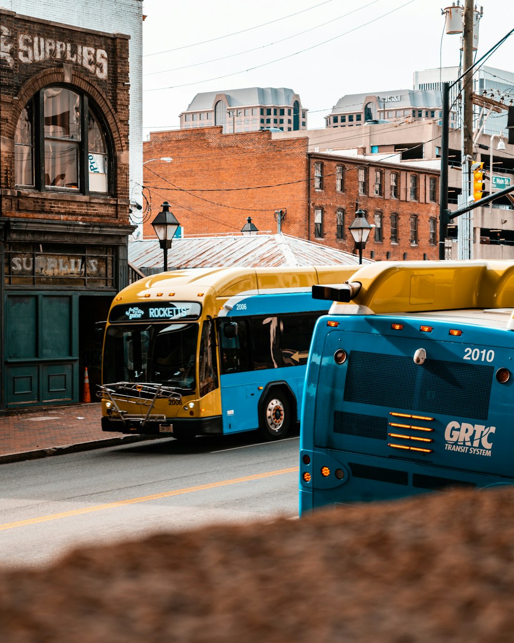 blue and yellow bus on road during daytime