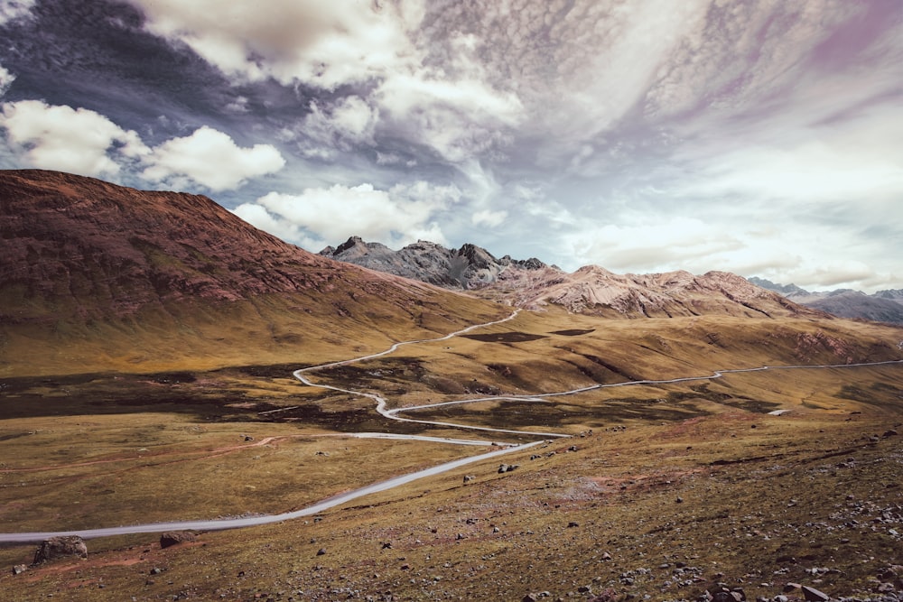 brown and gray mountains under white clouds