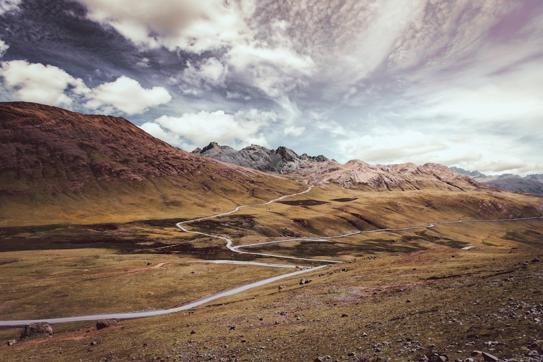 brown and gray mountains under white clouds,