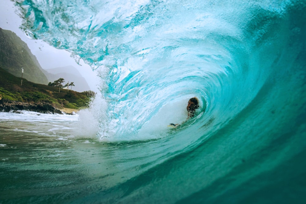 person surfing on sea waves during daytime