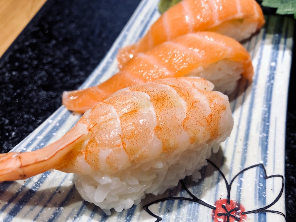 orange and white sushi on white plastic container