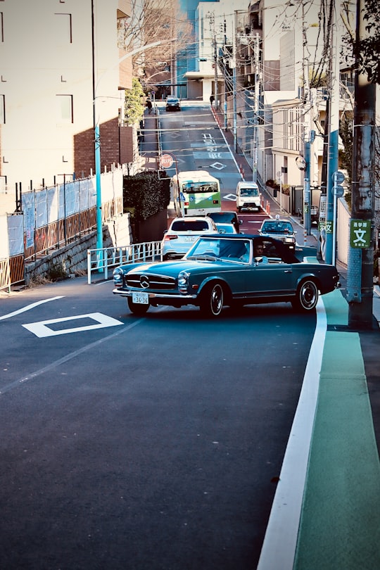 red coupe on road during daytime in Ebisu Station Japan