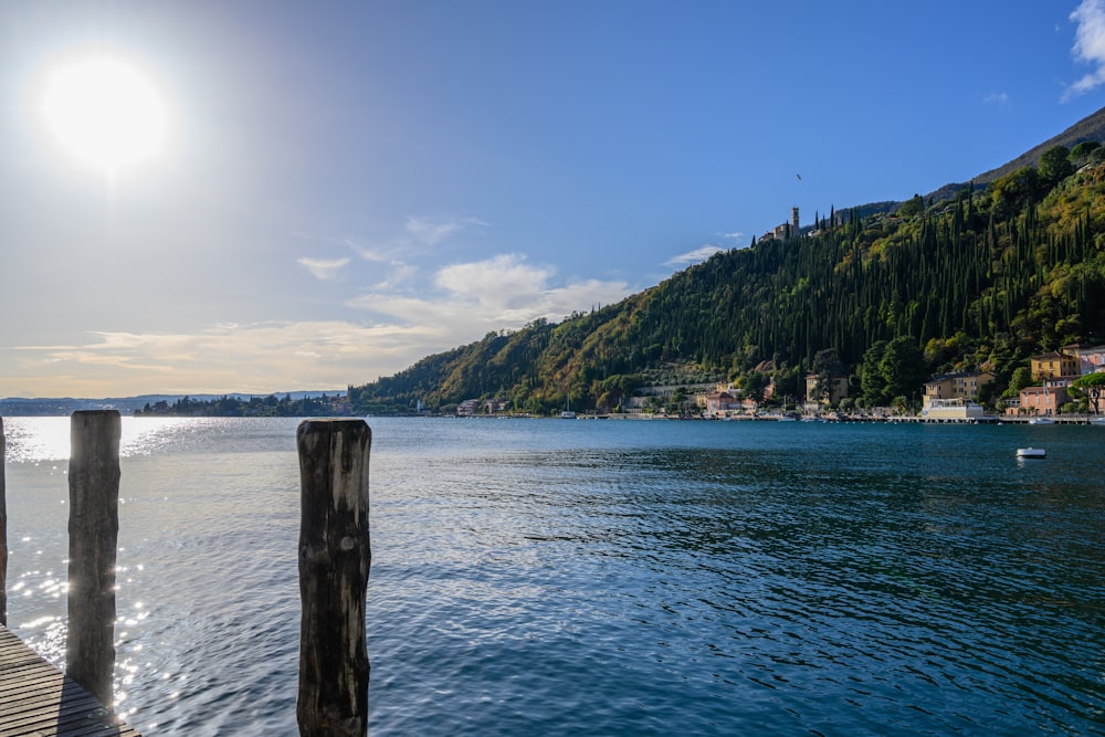 green mountain beside body of water during daytime