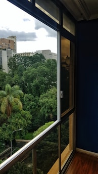 green trees near white concrete building during daytime