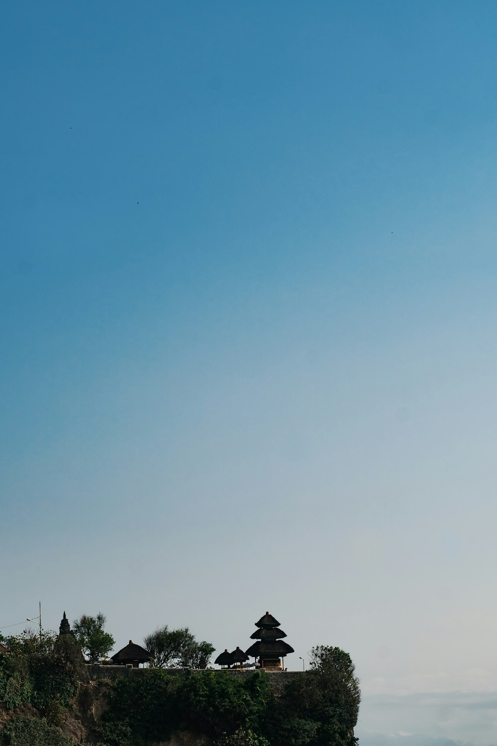 silhouette of house under blue sky during daytime