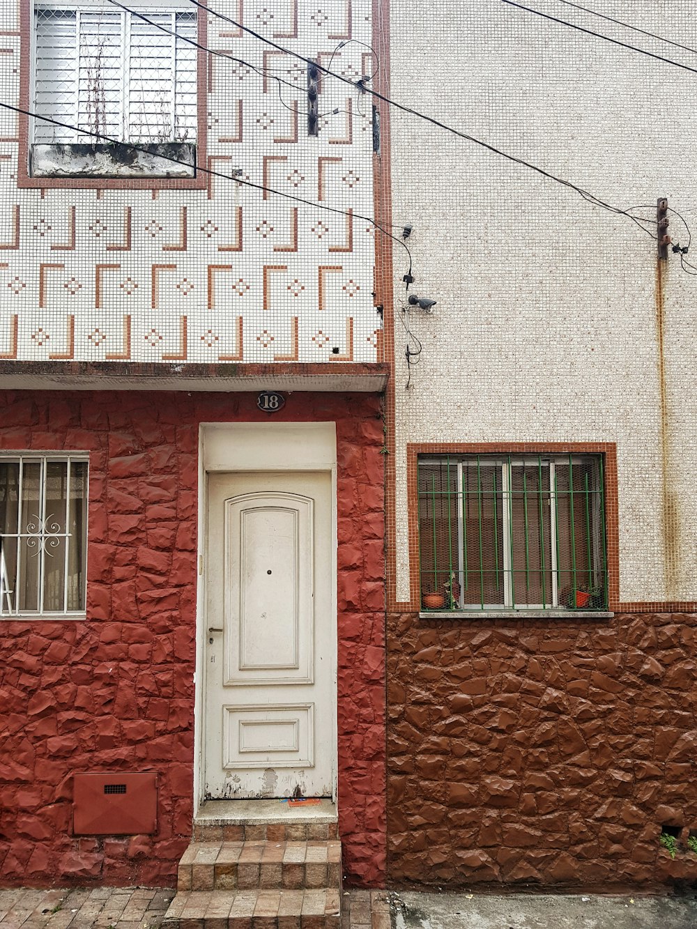 white wooden door on brown brick wall