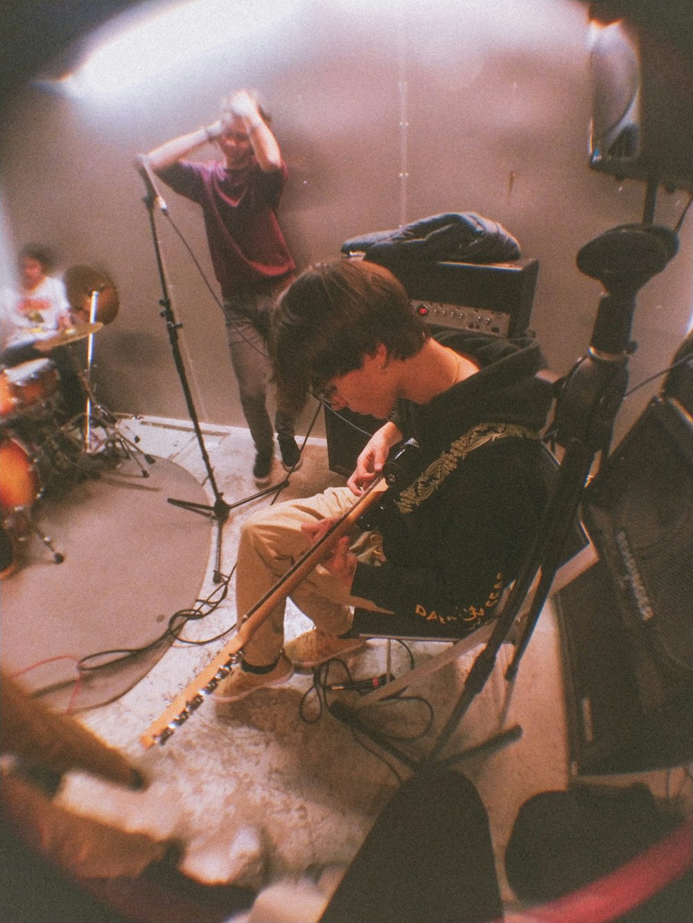 man in black shirt playing guitar