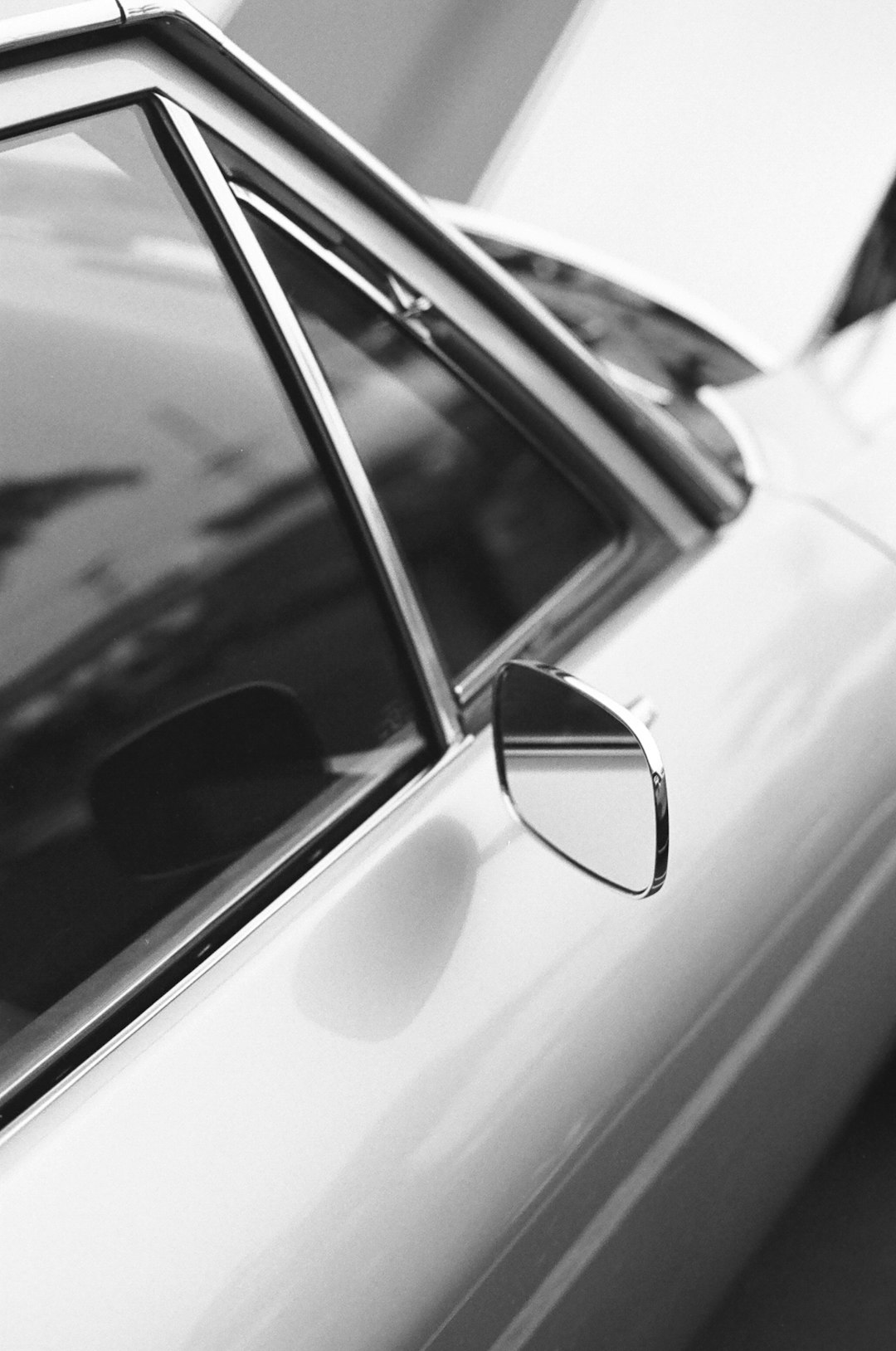 grayscale photo of car side mirror