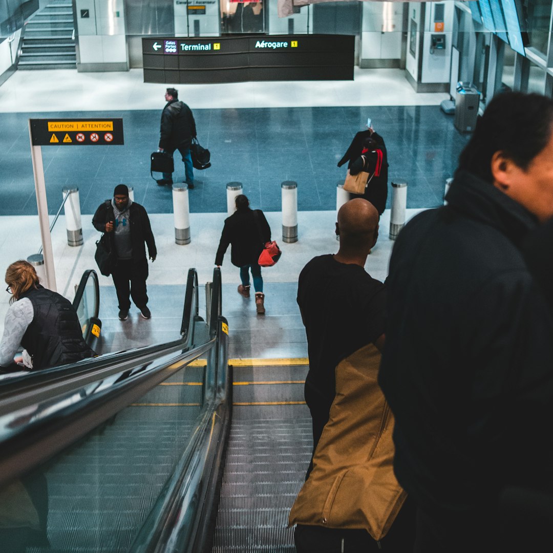 people walking on escalator inside building