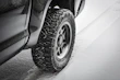 Winter tires with deep treads covered lightly with snow